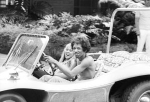 Jimi Hendrix driving a dune buggy with an unidentified woman on October 6, 1968.  