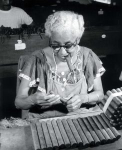 Cigar factory worker job, smoke-testing cigars, Havana, 1960s.