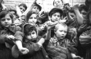 Child survivors of Auschwitz display tattoos.