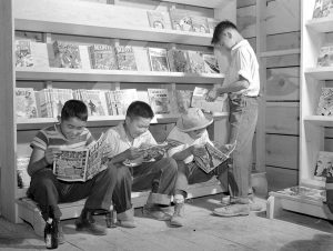 Japanese-American internees read comic books, Newell, California, 1942.