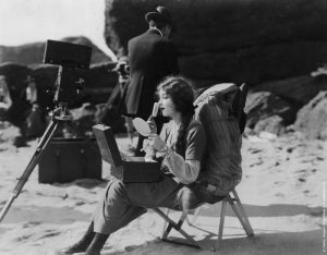 Chaplin's 1st wife, applying make-up between production shoots.
