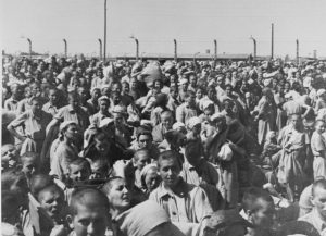 Ukrainian Jewish women, disinfected & bald, await fate.