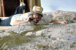 Steven Spielberg considers a miniature while filming 