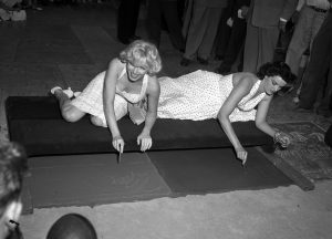 Monroe & Russell immortalize fame in wet cement, 1953.