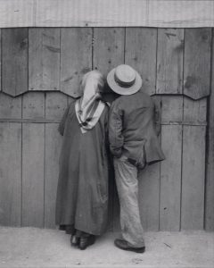 Watching the circus from a peephole, Budapest, 1920.